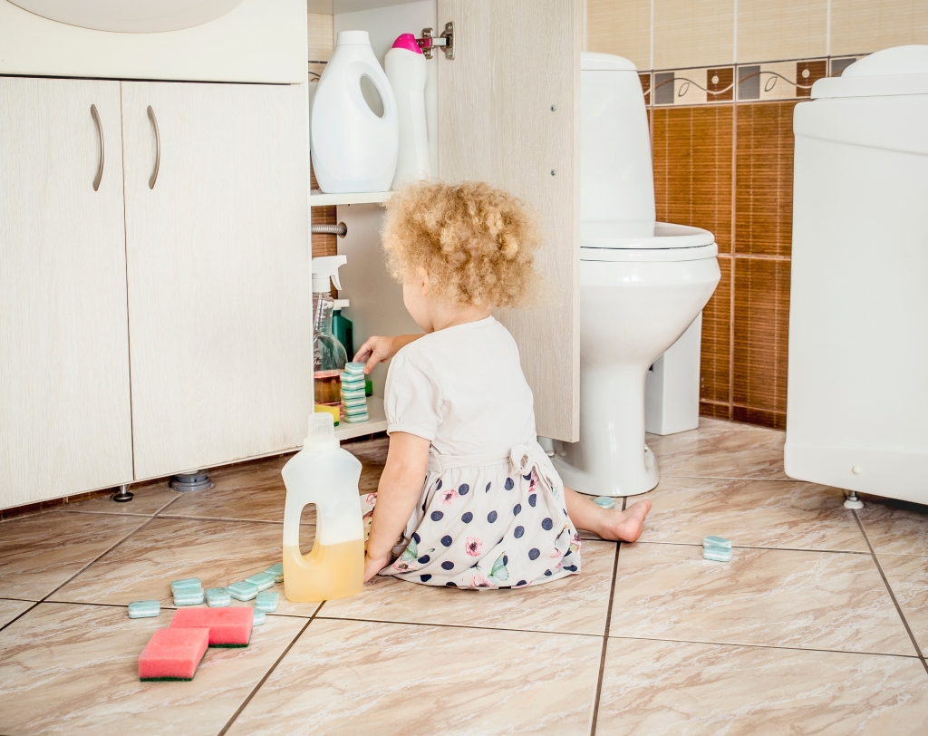 Toddler dangerously playing with chemicals in the bathroom